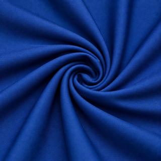 A close-up of royal blue fabric arranged in a spiral swirl, showing the material's texture and drape.