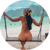 Woman on a swing at a beach with a clear blue sky